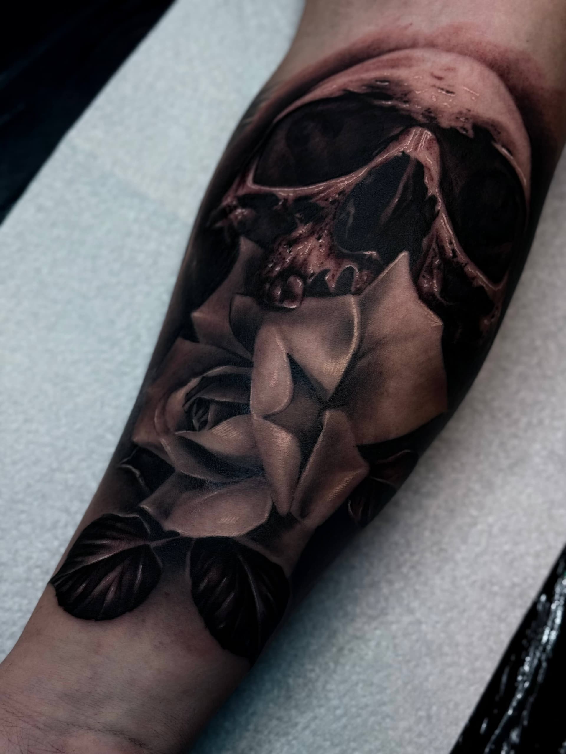 Black & Grey Totenkopf Tattoo mit Rose am Unterarm